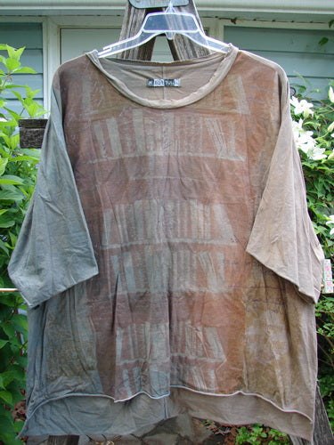 Barclay Raw Edge Flutter Collar High Low Top in Mottled Latte features a rounded batiste flutter neckline, short raw edge dolman sleeves, and a distinctive hi-low hemline with a vertical rear seam.