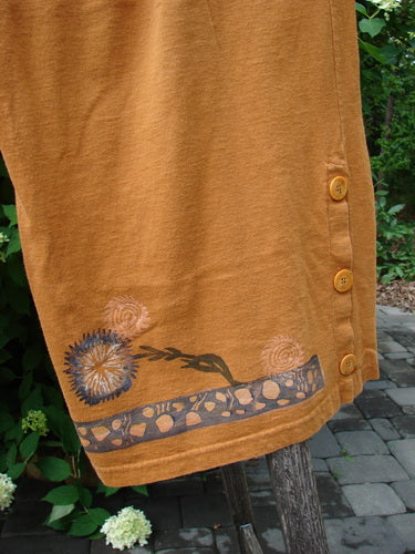 1994 Banjo Pant Dandelion Breeze Oro Size 2 features three side buttons and a decorative hem with dandelion motifs, draped outdoors, embodying BlueFishFinder's vintage aesthetic and creative expression.