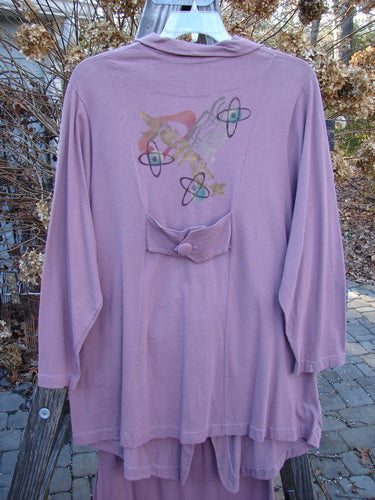 1996 Boulevard Festival Duo Laurel Size 1: A purple shirt with a design on it, featuring stars and planets.