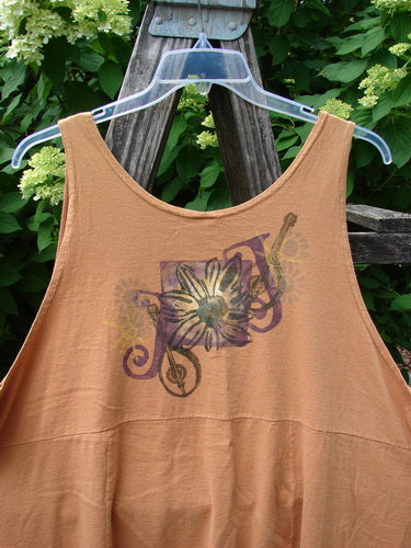 1994 Short Simple Smock Double Daisy Oro Size 1, featuring a loose, sleeveless design with a stylized floral and musical motif across the chest, displayed on a clear hanger.