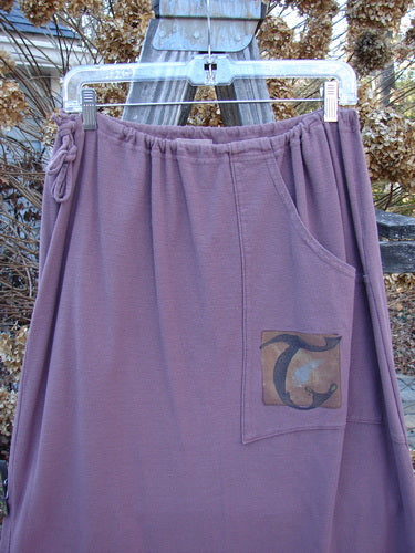 2000 Crepe Rennai Lindrel Duo Loam Size 2: A purple skirt with a patch on it, part of the Fall Collection.