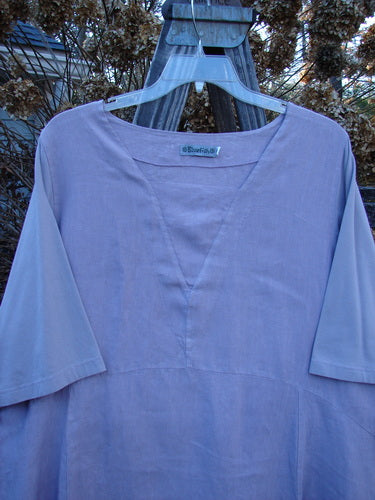 Barclay Linen Cotton Sleeve Triangle Dress on a swinger. Features empire waist, varying hemline, drop side pockets, and longer cotton sleeves. Size 2, lavender color.