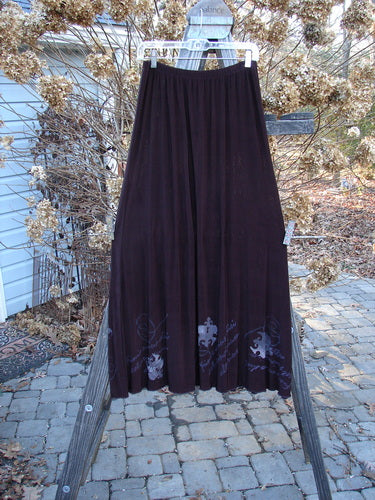 1999 Acetate Streamer Moonbeam Duo Key Deep Burgundy Size 1: A long purple skirt and a black dress with a white design.