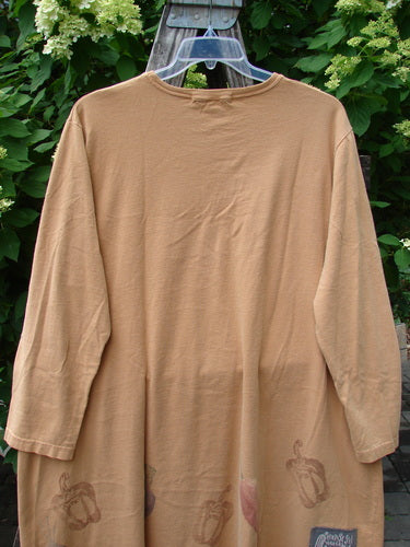1998 Vegetable Tunic Top Bountiful Garden Ochre Size 2, loose-fitting with an A-line shape, features a softly rolled neckline and a sweet veggie motif along the hem, hanging outdoors.