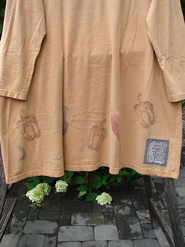 1998 Vegetable Tunic Top Bountiful Garden Ochre Size 2, featuring bell pepper prints along the hem and a Blue Fish patch, draped over a wooden frame, highlighting its A-line shape and scooped neckline.