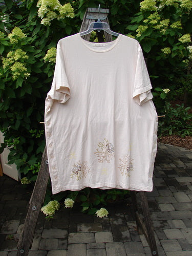 1997 Mauritius Top Sea Coral Powder OSFA displayed on a hanger, features botanical motif near hem, lush green hydrangeas in the background, embodying BlueFishFinder's vintage, creative, and unique style.