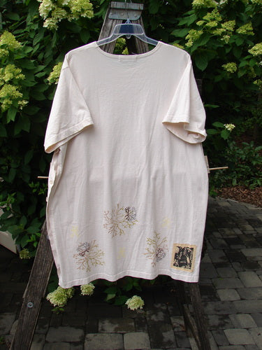 1997 Mauritius Top Sea Coral Powder OSFA, displayed on a hanger over a wooden structure, features nature-inspired prints, floral buttons, and side vents, embodying BlueFishFinder's vintage creative expression amid outdoor greenery.