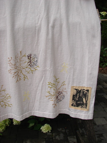 1997 Mauritius Top Sea Coral Powder OSFA: Light-colored mid-weight organic cotton with abstract coral motifs in muted tones; features a signature black and cream deer patch, floral buttons, and tall side vents.