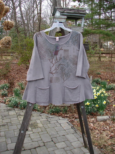 Barclay NWT Fleece Cafe Sweatshirt with Pearl Path design on a grey shirt with tree print, outdoor setting.