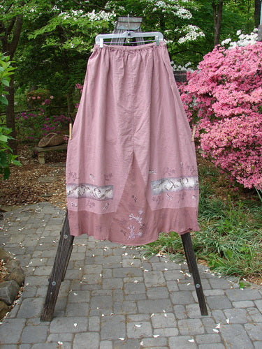Barclay Linen Duet Skirt Falling Fern Dried Rose Size 2: A wide bell-shaped skirt with a V-shaped insert and a varying hemline. Features tiny floral and falling fern theme paint and a cotton lower flutter.