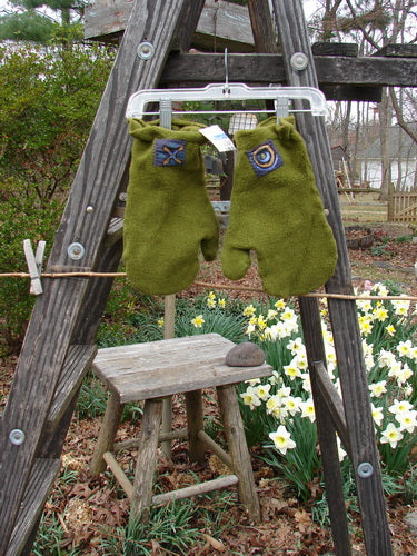 2000 NWT Patched Celtic Moss Mittens on clothesline with wooden stool with flowers