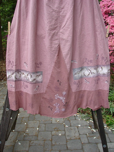 Barclay Linen Duet Skirt Falling Fern Dried Rose Size 2: A pink dress with a floral design and a widening bell shape.