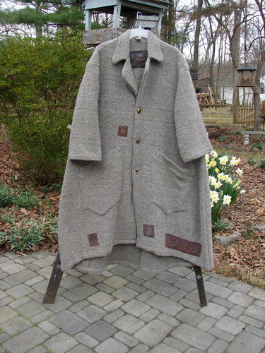 2000 Patched Spun Wool Cormac Coat Celtic Period Cloud Grey Size 1, a coat with patchwork on a rack.