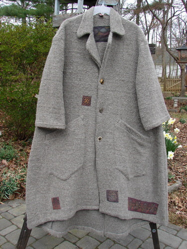Vintage grey coat on clothes rack, Celtic period style.