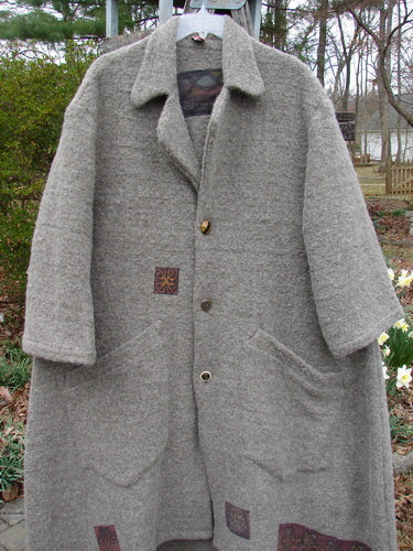 Vintage Grey Coat on Clothes Rack, close-up.