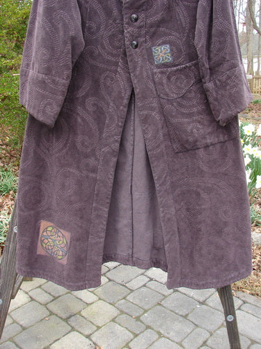 Vintage 2000 Patched Upholstery Diwmach Coat Celtic Time Aubergine Size 0, person wearing long purple patterned coat.