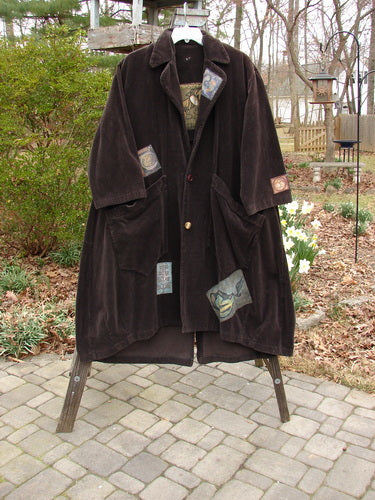 Vintage Patched Tapestry Coat on Rack, close-up details of arm and chair, outdoor cloak with mantle, 