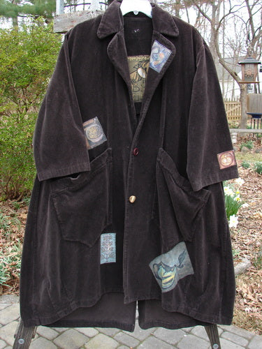 Vintage 1998 Patched Tapestry Coat with hem repair top button spots, outdoor coat with patches, close-up cloth detail.