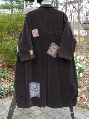 1998 Patched Tapestry Coat with person wearing black skirt and tattooed arm, outdoor setting.