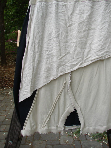 A close-up of a white sheet with a hole in it, part of the Barclay NWT Mixed Media Swatch Skirt.