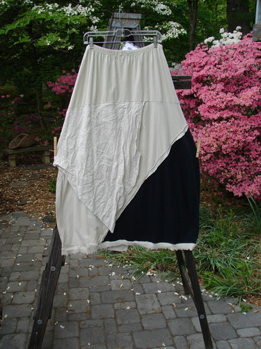 Image alt text: Barclay NWT Mixed Media Swatch Skirt on clothes rack, featuring layered upper, sectional panels, and full elastic waistline.