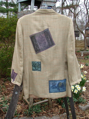 Vintage 1994 Patched Blazer with nature-inspired elements, including a moose and deer, on fabric, hanging on a rack.