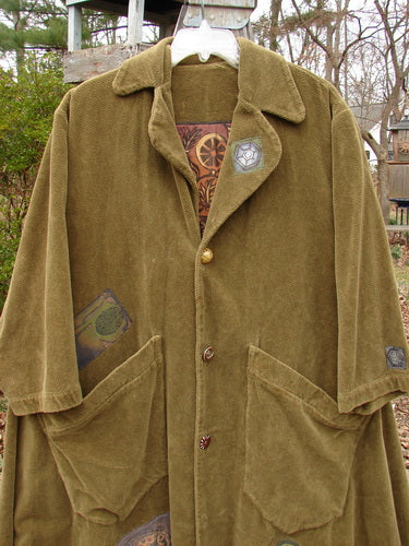 Vintage coat with unique patches and tapestry design, featuring a forest path and glazed tile.