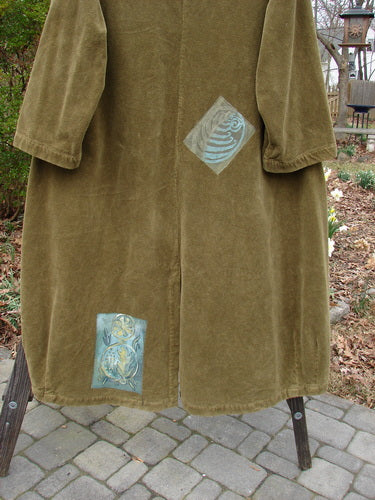 Vintage coat with unique patches, close-up details of fabric textures and patterns.