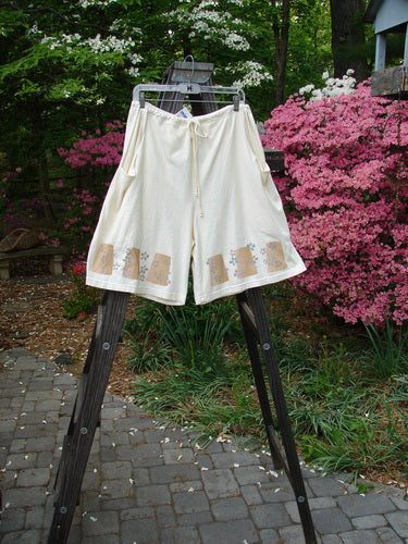 2000 NWT The Summer Short Tiny Daisy Milk Size 2: Mid-weight organic cotton shorts with deep front bushel pockets, drawstring waistline, and painted daisy accents. Mega pockets run down the entire short. Measurements: Drawstring 26-60, Waist 60, Hips 60, Inseam 9, Length 23.
