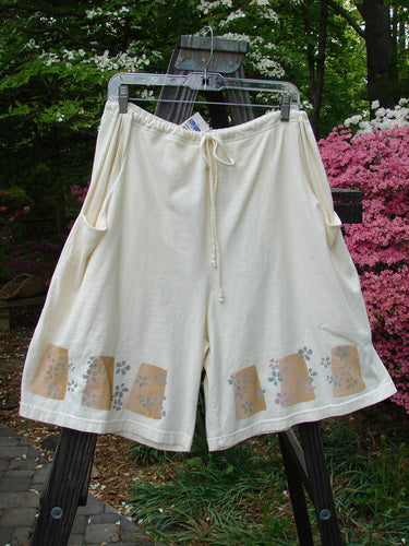 2000 NWT The Summer Short Tiny Daisy Milk Size 2: A pair of white shorts with a drawstring waistline and deep front bushel pockets. Features painted daisy accents and a flowy, swingy design.