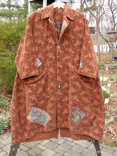 Vintage 1998 Patched Tapestry Coat with logo detail on stone floor, standing model.