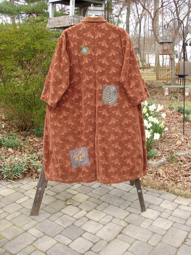 A vintage coat with intricate designs, inspired by nature and artistry.