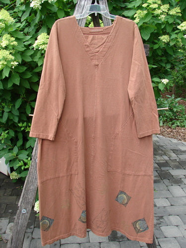 1998 Mandolin Dress Lucky Horseshoe Rockwood Size 2 features a loose fit, V-neckline, large front pockets, and decorative hem patches. Displayed on a patio, symbolizing Bluefishfinder.com's vintage charm and creative expression.