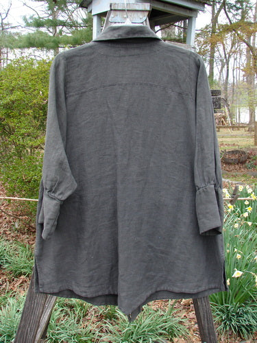 Barclay Linen Metal Button Drop Pocket Pullover Unpainted Grey Storm Altered Size 2 displayed on a clothes rack, featuring a modified elastic loop button line, slightly billowy cuffed sleeves, and double drop front pockets.