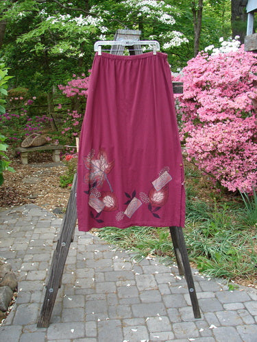 Barclay Panel Nut Button Vented Skirt in Oakleaf Madder, Size 2. Straight shape with tall vented sides and nut-like buttons. Elastic waistline and leaf-themed paint around the hemline.