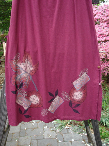 A Barclay Panel Nut Button Vented Skirt in Madder, featuring a leaf theme paint all around the hemline. Size 2.