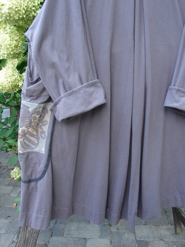 1998 Tiddly Winks Jacket Butterfly Madeira Size 2, a long-line garment with draped front panels, turned-up sleeves, and decorative pocket, highlighted by elaborate butterfly paint and textured piping, photographed outdoors.