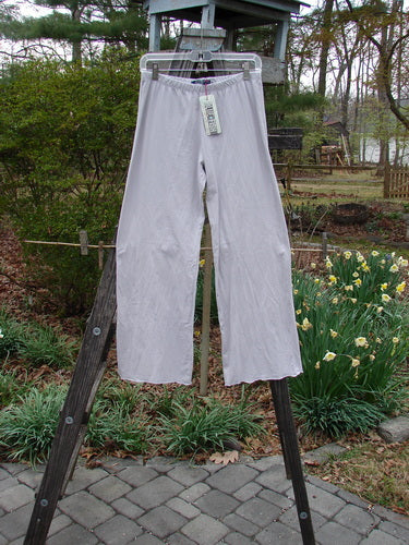 Barclay NWT Simple Cha Cha Pant Unpainted Ricepaper Size 0 hanging on a clothesline, showcasing slightly flared curly lowers, shallow rise, shorter inseam, and pocketless design, perfect for summer wear.