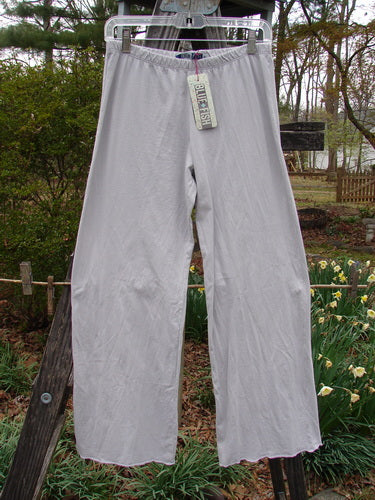 Barclay NWT Simple Cha Cha Pant Unpainted Ricepaper Size 0 hanging outdoors on a clothesline, showcasing its lightweight organic cotton and slightly flared lower design.