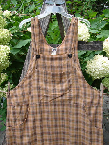 1999 Patched Overall Jumper Mixed Far Eastern Gold Plaid Size 2 displayed on a wooden ladder, showcasing adjustable straps, front bib pockets, and unique Far Eastern patches, highlighting its vintage charm from Bluefishfinder.com.