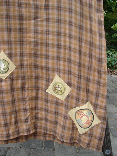 1999 Patched Overall Jumper Mixed Far Eastern Gold Plaid Size 2 features brown-and-orange plaid fabric with three square patch-appliqués, showcasing intricate motifs, in an outdoor display, embodying vintage BlueFishFinder style.