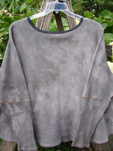 Barclay NWT Thermal Crop Top Belief Magic Mottled Spirit OSFA displayed on a clear hanger, showcasing its rounded scooped neckline, cropped length, drop shoulders, and waffle texture against a wooden backdrop.