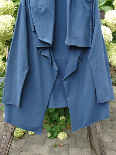 Barclay Cotton Lycra Gather Collar Open Front Jacket Unpainted Navy Size 2 draped on a stool outdoors, showcasing its unique drawcord neckline, dual pockets, and flowing hemline.