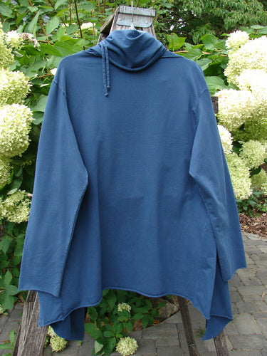 Barclay Cotton Lycra Gather Collar Open Front Jacket Unpainted Navy Size 2 displayed on a wooden ladder, showcasing its asymmetrical drape, long sleeves, and unique drawcord neckline against a garden backdrop.