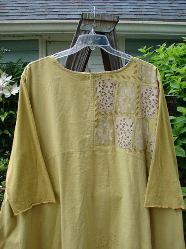 A long sleeved shirt on a swinger, featuring a Barclay Cotton Sleeve Hemp Linen Sectional Dress in Mustard from Bluefishfinder.com.