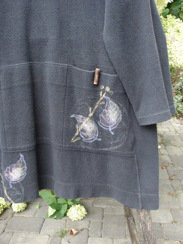 1998 Heavy Berber Kindlewood Tunic Leaf Sprig Black OSFA, featuring hand-painted botanical motifs, two front pockets, and a wooden toggle at mid-front, displayed outdoors on a wooden support.