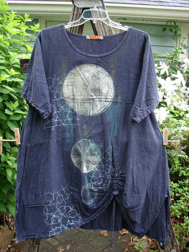 Barclay Hemp Vented Drawcord Dress Moon Night Denim Size 1 features a rounded neckline, kangaroo pocket, and curved empire waist. It has painted wide sleeves, vented sides, and a generous A-line lower design.