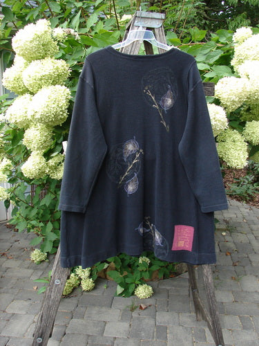 1998 Heavy Berber Kindlewood Tunic Leaf Sprig Black OSFA displayed on a wooden ladder, showcasing botanical-style prints in muted purples and browns, emphasizing its textured cotton Berber knit and cozy design.