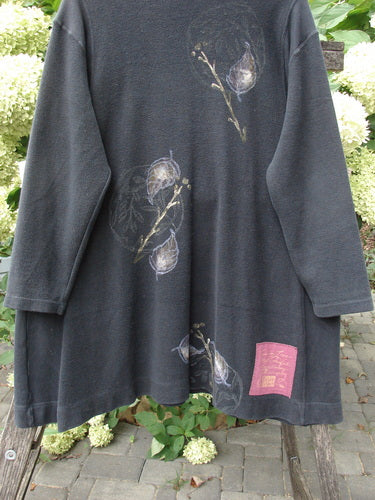 1998 Heavy Berber Kindlewood Tunic Leaf Sprig Black OSFA displayed on a bench, featuring an asymmetric hem, three-quarter sleeves, botanical motifs, and a magenta label, embodying Bluefishfinder.com's vintage charm.