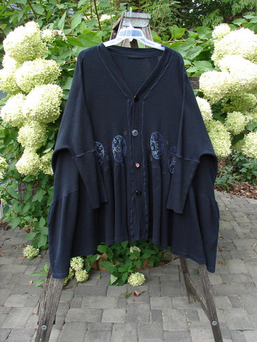 1997 Thermal Bungalow Jacket Celtic Medallion Cast Iron OSFA, features oversized buttons and Celtic medallion design, hangs on a stepladder, highlighting its ribbed cuffs and flounced hem, showcasing vintage Blue Fish creativity.